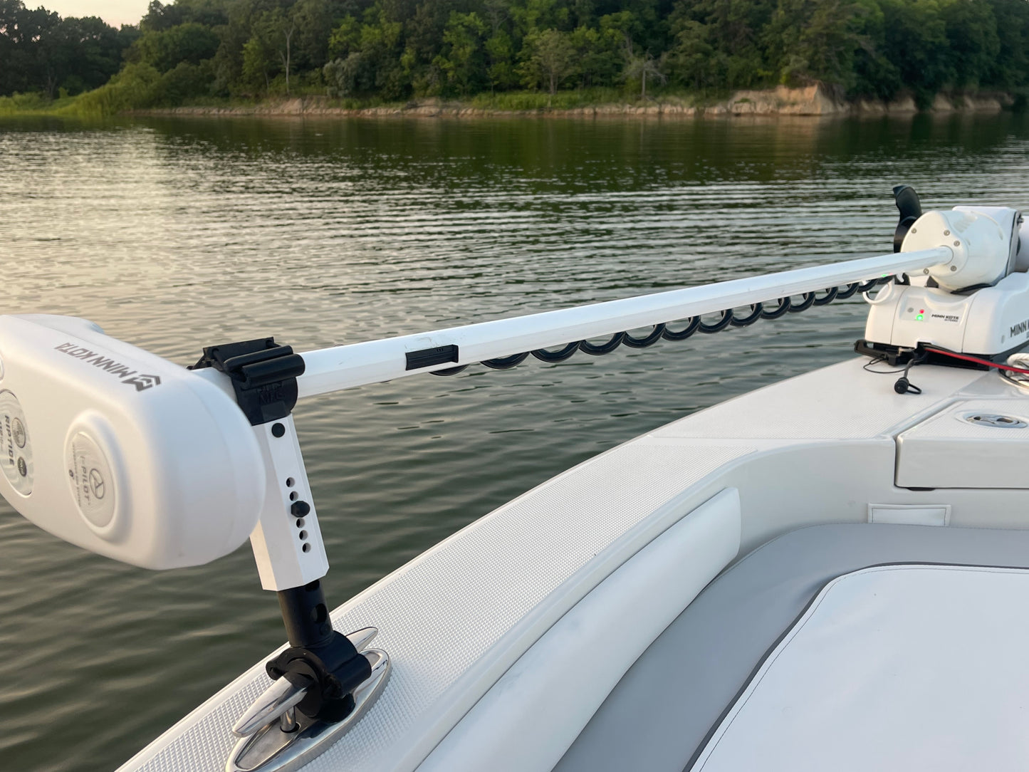 White Staymo trolling motor stabilizer attached to the boat pull up cleat with a lake in the background