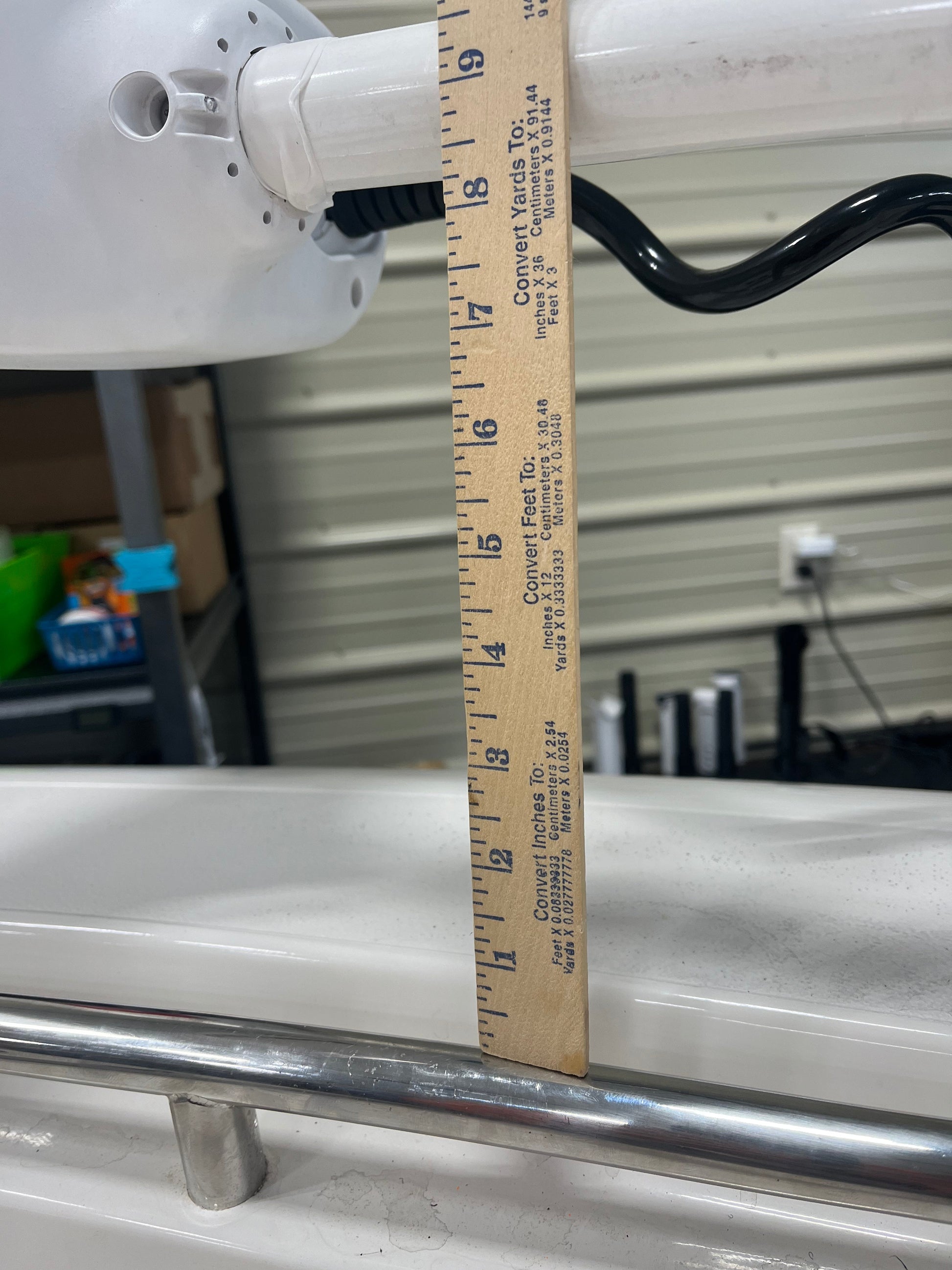 A ruler showing how to measure distance from  bow rail to trolling motor