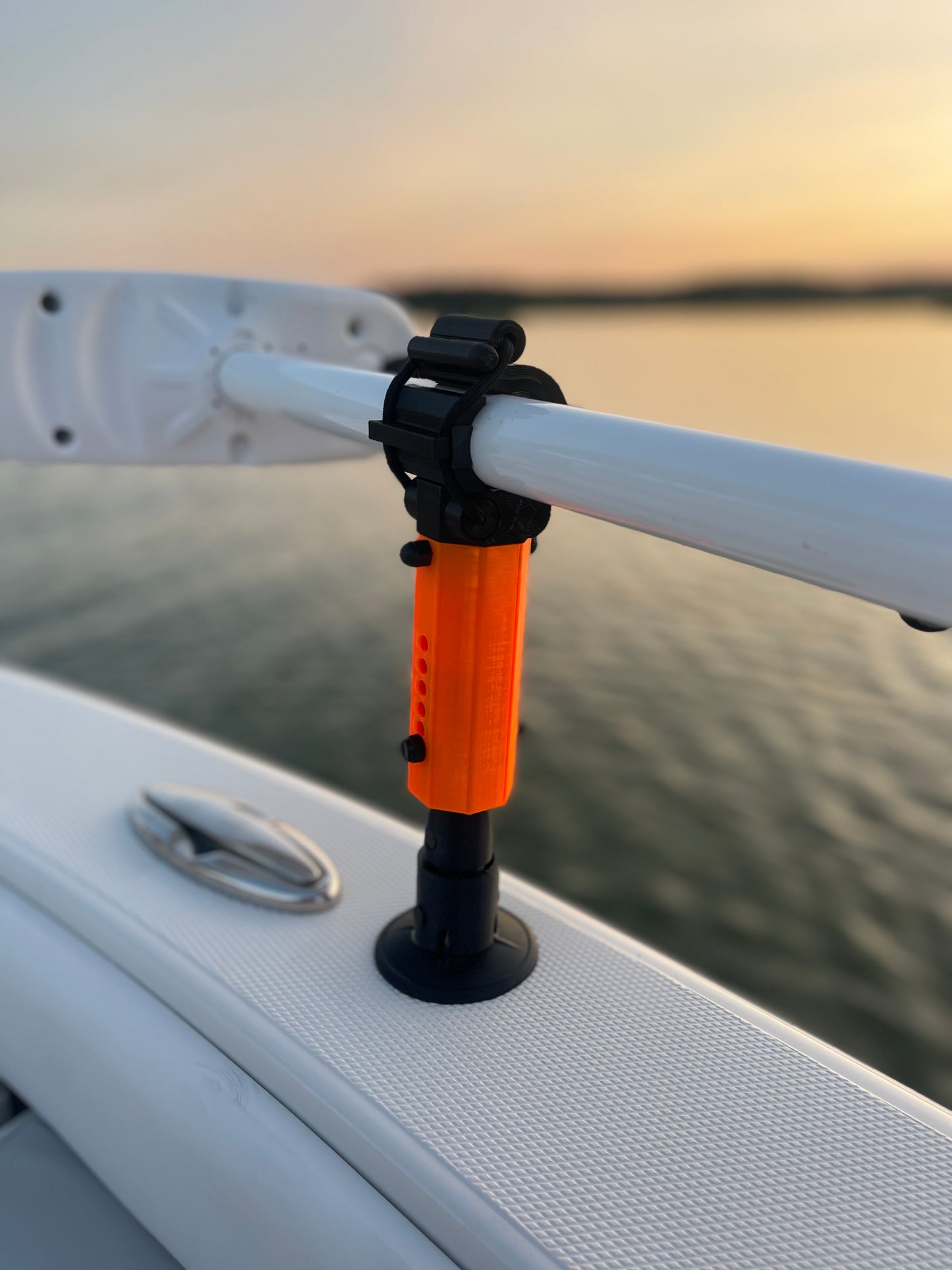 Ultra Orange Staymo trolling motor stabilizer attached to the boat deck with a sunset background