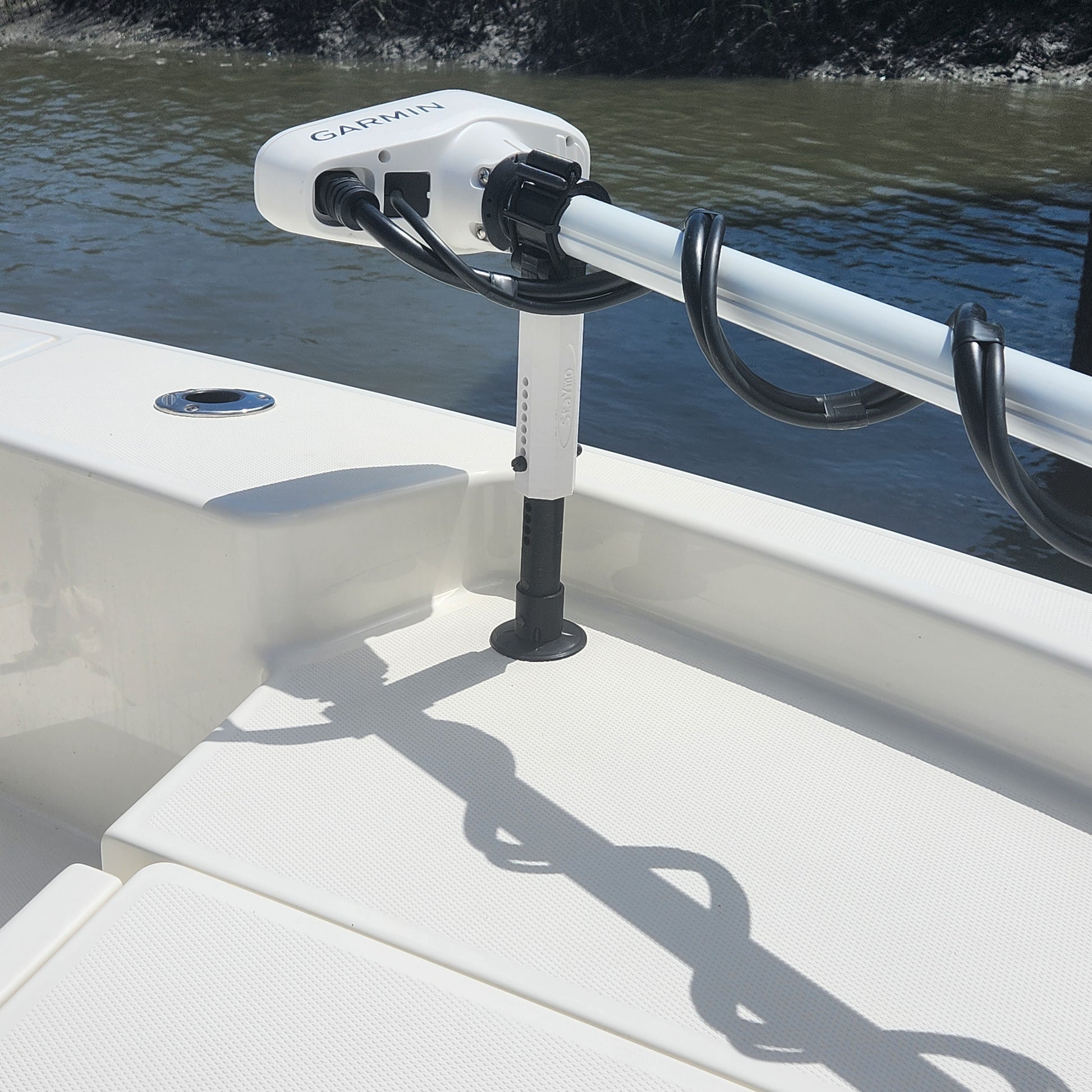 White Staymo shock absorber/stabilizer pictured supporting a trolling motor attached to the boat deck